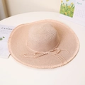 Detail of wide brim straw sun hat with frayed edges and beige bow accent for beach - M / Nude Pink