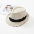 Dettaglio di cappello in paglia beige chiaro con nastro nero su tessuto - L (58-60cm) / Beige