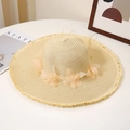 Close-up of summer straw hat with lace flowers, pearl accents and frayed brim edges - M / Beige