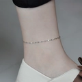 Minimalist silver stainless steel anklet with fine links shown on a woman's ankle - Lips Chain Anklet / Steel