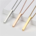 Macro shot of minimalist vertical bar pendants in silver, gold, and rose gold finishes - Steel