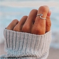Minimalist wave-shaped 316L stainless steel ring worn on a model against a beach backdrop - US Size 5 (49mm) / Steel