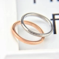 Macro detail of minimalist rings showing rose gold polished and silver frosted finishes - US 5 (49mm) / 2mm Width / Steel