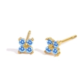 Macro detail of gold four-leaf clover earrings with light blue birthstone petals - March Light Blue (Aquamarine Color)