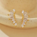 Orecchini a ala dorati con cristalli marquise su un bordo di ceramica elegante - Argento 925 / Oro