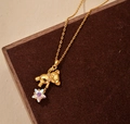 Primer plano detallado de un colgante de oso dorado con una estrella iridiscente brillante - Oro de 18K