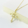 Makroaufnahme der goldenen Kreuzkette mit klaren Zirkoniasteinen an feiner Kette - Vollständiges 925 Sterling Silber / Gold