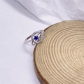 S925 sterling zilveren ring met een blauwe stersteen en sprankelende zirkoon-baan - US 6 / Witgoud