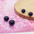 Elegant S925 silver drop earrings with black onyx beads over a natural wooden stand - 925 Silver / White Gold