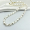Elegant natural freshwater pearl necklace with gold clasp on white silk background - 925 Silver / Gold