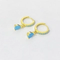 Detail of gold drop earrings featuring sky blue teardrop stones and pavé accents - Turquoise Gold Color