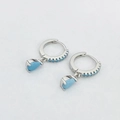 Detailed view of silver hoop earrings featuring blue zircon pavé and teardrop pendants - Turquoise Silver Color