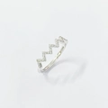 Detailed view of wave-shaped S925 sterling silver ring with sparkling zircon pavé setting - Adjustable Open / White Gold