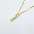 Detailed macro of gold letter pendant necklace with shimmering zircon stones on white background - Letter I / 925 Silver Gold Plated