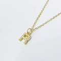 Macro detail of gold-plated letter R pendant necklace with paved zircon stones - Letter R / 925 Silver Gold Plated