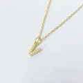 Macro view of gold initial V pendant with sparkling zircons on a delicate chain necklace - Letter V / 925 Silver Gold Plated