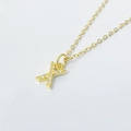 Macro shot of gold X-letter pendant with pavé cubic zirconia on O-chain necklace - Letter X / 925 Silver Gold Plated