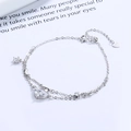 Bracciale in argento 925 con ciondoli a luna e stella ed elementi in cristallo a goccia - Argento 925 / Oro Bianco