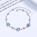 S925 sterling silver bracelet with three blue zircons in a minimalist swirl setting - 925 Silver / Blue Zirconia - Platinum Color