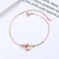 Elegante roségouden armband met in elkaar grijpende driehoeken en sprankelende zirkonia - 925 zilver / Roségoud