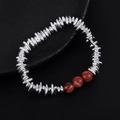 Macro detail of silver beads and red agate stone beads on minimalist elastic bracelet - Red