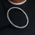 Macro shot of silver stainless steel bracelet featuring spiral texture beads and cylinders - Spiral Textured Bead Bangle (S422-A)