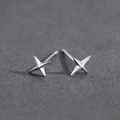 Macro shot of minimalist silver four-point star stud earrings on a dark textured background - Cross Star Stud Earrings / Silver (X118-A)