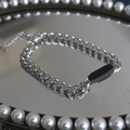 Silver cuban link bracelet for men featuring a black rectangular plate on a vanity tray - Black Label Style (S074-A)