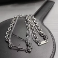 Macro view of multi-layer silver metal chain necklace with a star pendant and diamond - L223-A (Cross Splicing Necklace)