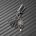 Macro view of vintage silver skull carabiner hook with punk gothic keychain detailing - Silver