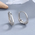 Elegant silver U-shaped hoop earrings with micro-set zircons on light textured background - Silver