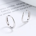 Polished S925 sterling silver Mobius twist hoop earrings on a clean white surface - 925 Silver / White Gold