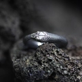 Retro ouroboros snake ring with textured scales and silver accents on dark volcanic rock - Ouroboros Style (J040-A)