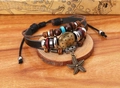 Detailed close-up of layered leather bracelets with wooden beads and starfish pendants - Black
