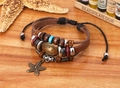Detail of vintage layered leather bracelet with wooden beads and starfish pendant - Brown