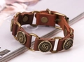 Detail of vintage brown leather punk bracelet with engraved bronze metal ornaments - Brown