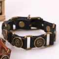 Vintage punk style black leather bracelet with bronze spiral metallic circular charms - Black