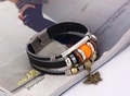 Close-up of multilayer leather bracelet with bronze butterfly charm and metal beads - Black