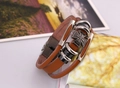 Detail of vintage multilayer brown leather bracelet with cross charm and metal beads - Tan