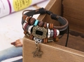 Close-up of bohemian multilayer leather bracelet with star charm and vintage beads - Black