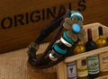 Detail of vintage multilayer braided leather bracelet with floral pendant and turquoise beads - Blue Center