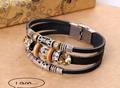 Macro view of multi-layer black leather bracelet with crystal beads and metal tube accents - Black