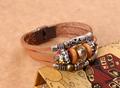 Detail view of multi-layer leather bracelet with vintage beads and magnetic metal clasp - Tan