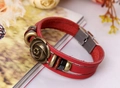 Close-up of vintage red leather multilayer bracelet with bronze rose charm detail - Red