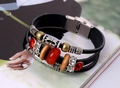 Detail of retro leather bracelet featuring red beads and magnetic stainless steel clasp - Black