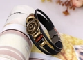 Detail of multi-layer leather bracelet with bronze rose and wooden beads on prop - Black