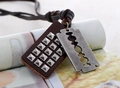Detailed close-up of retro double-pendant leather necklace with studs and blade charm - Blade Shape