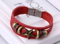 Detail of red multilayer leather bracelet featuring bronze star charm and magnetic clasp - Red