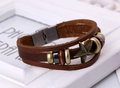 Detail of multi-layer brown leather bracelet with bronze star and metallic charms - Dark Brown
