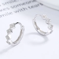 Elegant 925 sterling silver wave hoop earrings with pavé cubic zirconia on white background - 925 Silver / White Gold
